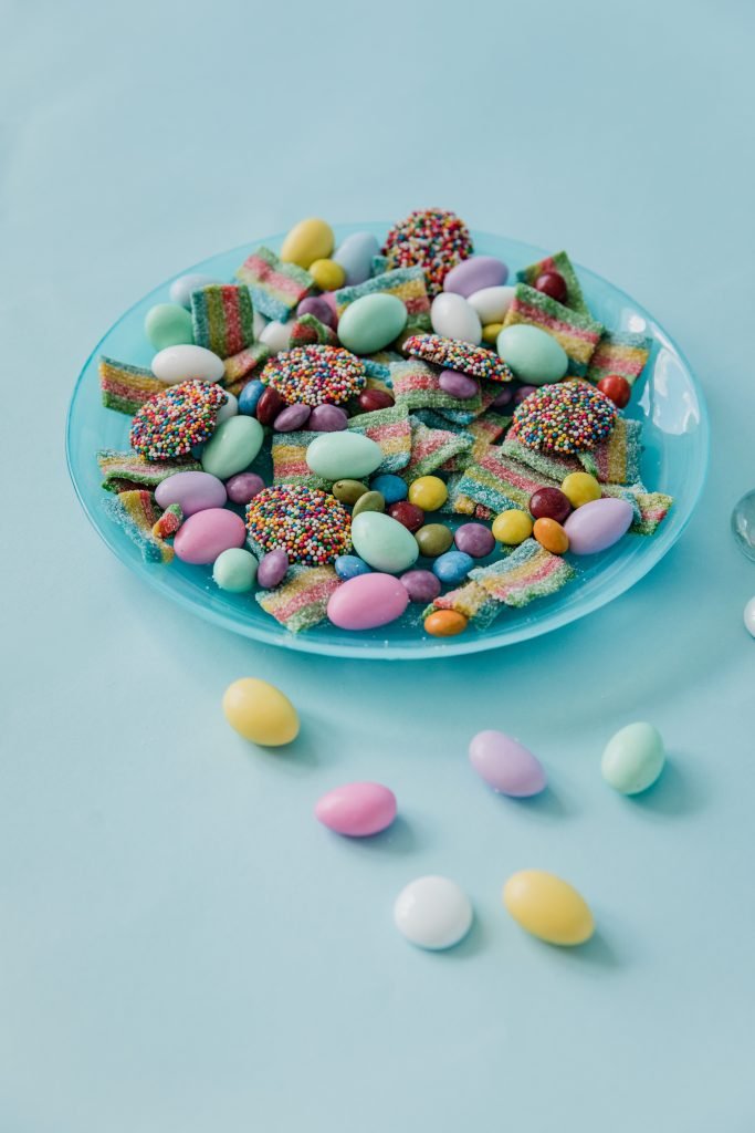 A vibrant display of assorted colorful candies on a blue plate, perfect for sweets lovers.